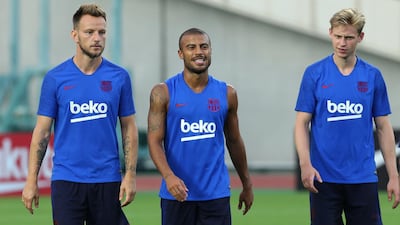 Barcelona's Ivan Rakitic, left, Rafinha, centre, and Frenkie De Jong relax during training. EPA