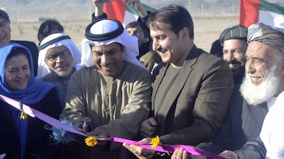 Juma Al Kaabi (centre left), UAE's Ambassador to Afghanistan, cuts a ribbon with Dr Humayoon Azizi (centre right), the Governor of Kandahar province, during a ceremony in Kandahar, Afghanistan. Kandahar Gov Office / EPA