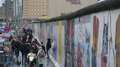 Visitors walk along a still-standing section of the former Berlin Wall called the East Side Gallery in Berlin, Germany. At least 136 people, many of them shot dead by East German border guards, were killed trying to escape. Getty Images