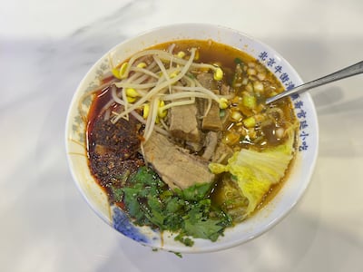 Thin slices of meat are cooked in a clear, bubbling broth. Saeed Saeed / The National