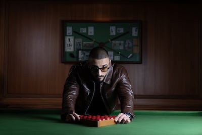 Jacket and top, Dolce & Gabbana. Sunglasses and watch, Mohamed’s own. Chris Whiteoak / The National