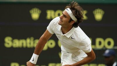 Roger Federer serves against Santiago Giraldo during his third-round win on Saturday at the 2014 Wimbledon Championships. Andrew Yates / AFP / June 28, 2014