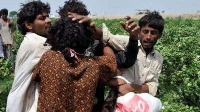 Flood survivors in Khairpur fight for a food bag dropped from a helicopter yesterday. Two million have been left homeless by the disaster.