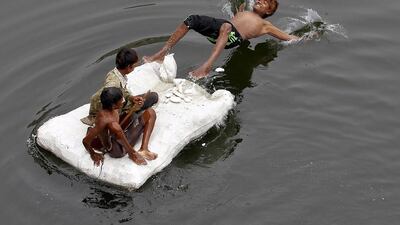 A boy jumps from a raft into the Sabarmati river to cool off in the western Indian city of Ahmedabad. Amit Dave / Reuters