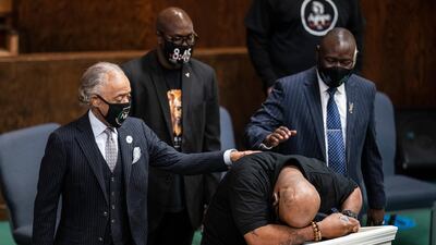 Terrence Floyd, brother of George Floyd who died in the custody of white police officers, breaks down during a prayer service at Greater Friendship Missionary Church, as Rev Al Sharpton, left, his brother Philonise Floyd and lawyer Ben Crump, right, try to console him, on Sunday, March 28, 2021, in Minneapolis. AP