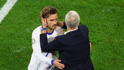 France's Antoine Griezmann embraces coach Didier Deschamps after being substituted against Austria. Reuters