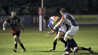 Jebel Ali Dragons, white, and Dubai Exiles, black, in action.