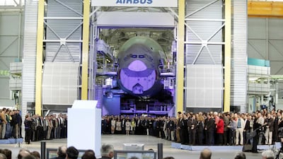 Workers gather in front of the nose cone of an Airbus A380 at the opening ceremony for the new final-assembly plant at Airbus's Toulouse. Bloomberg