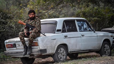 Volunteer fighters stand in a village south-east of Stepanakert during the ongoing fighting between Armenian and Azerbaijani forces. AFP