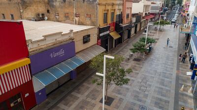 Stores are closed during a lockdown to stop the spread of the new coronavirus in downtown Ribeirao Preto, Sao Paulo state, Brazil. The city imposed strict shutdown measures this week to stop the spread of COVID-19, halting public transportation for the first time and closing supermarkets. AP Photo