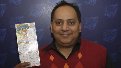 Urooj Khan, 46, of Chicago, poses with a winning lottery ticket. He died a day after collecting his cheque.
