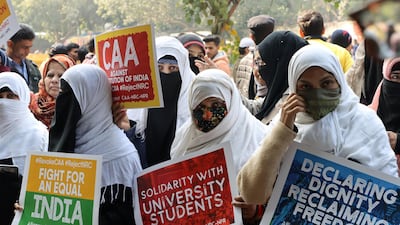 Demonstrators hold up placards while gathering to protest against the Citizen Amendment Act at Jantar Mantar in New. Bloomberg