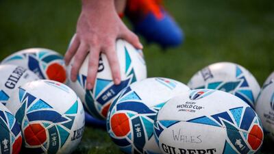 A player picks up an official tournament ball during a Wales team training session in Tokyo. AFP