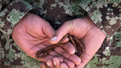 A soldier with the Afghan National Army (ANA) holds prayer beads during a basic training graduation ceremony at the ANA’s combined fielding centre. Scott Olson / Getty / March 18, 2014