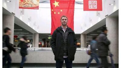 Ted Feierstein, 26, who works in Shanghai for a renewable energy company. Standing in the busy Peoples Square Underground station with passing-by Chinese. Jon Browning for The National