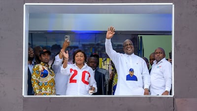 The President Felix Tshisekedi with his spouse Denise Nyakero greet supporters after the announcement of the election results at the headquarters of his electoral campaign, in Gombe, Kinshasa. AFP