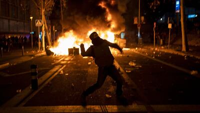 A man throws a missile during the Catalan pro-independence protest outside the Camp Nou. AP