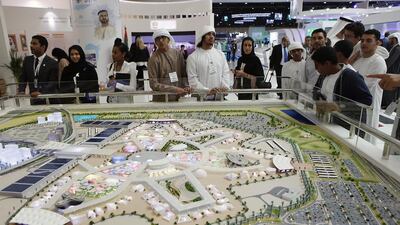 Visitors looks at a model of Expo 2020 at the World Future Energy Summit 2017 at the Abu Dhabi Exhibition Center. Ravindranath K / The National