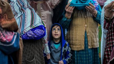 A Kashmiri Muslim boy stands with elders during special prayers at Hazratbal Shrine in Srinagar, Indian-controlled Kashmir. AP Photo