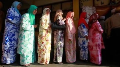 Malaysian voters line up at a polling station during election day in Pekan.