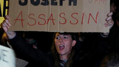 A protester holds a sign during a protest outside the Government Palace. Reuters