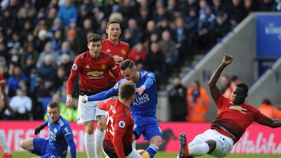Maddison, centre, and Manchester United's Luke Shaw challenge for the ball. AP Photo