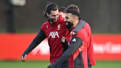 Dominik Szoboszlai shares a joke with Mohamed Salah during training. AFP