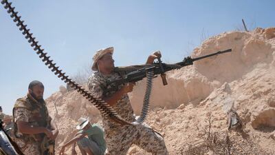A Libyan forces fighter shoots his weapon during a battle with ISIL fighters in Sirte. Goran Tomasevic / Reuters