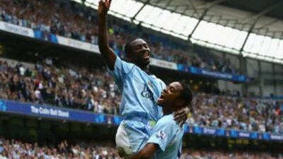 Shaun Wright-Phillips celebrates scoring Manchester City's fourth goal with team mate Robinho.