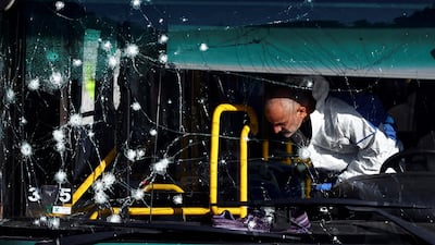 Israeli police inspect a damaged bus following an explosion at a bus stop in Jerusalem. Reuters
