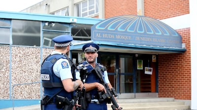 Police look on as locals lay flowers and condolences at the Huda Mosque in tribute to those killed and injured at the Al Huda Mosque on March 16, 2019 in Dunedin. Getty
