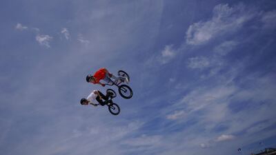 BMX riders perform in front of the Luxor Obelisk in Paris as he takes part in the "Journee Olympique" ("Olympic day". AFP