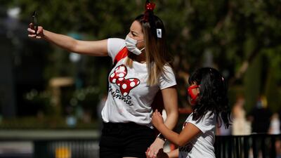 People take a selfie outside Disneyland Park on its reopening day amidst the pandemic, in Anaheim, California, US, on April 30, 2021. Reuters