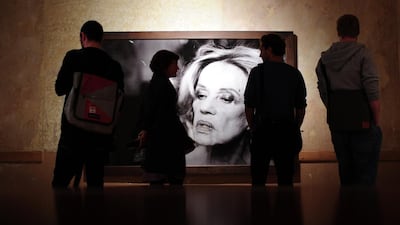 Visitors look at a 2003 photograph of Jeanne Mareau by Peter Lindbergh, at the exhibiton "On Street - Photographs and Film" 2010 in Berlin. Johannes Eiselle, AFP.