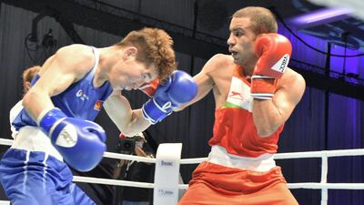 Amit Panghal ( red) lands a right jab on Kharkhuu Enkhmandakh in the Asian Boxing Championships at Le Meridien Grand Ballroom in Dubai on Wednesday, May 26, 2021. Courtesy BFI