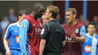 Emile Heskey, the Aston Villa forward, argues with Mike Jones, the referee, during their game against Wigan Athletic.