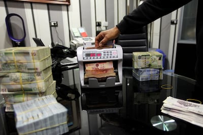 Libyan dinars are counted by machine at a currency exchange in Tripoli. Reuters
