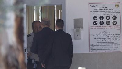The former Israel prime minister Ehud Olmert, centre, arrives at Maasiyahu prison, in Ramale, Israel. Olmert has to serve 19 months in jail after being found guilty of corruption charges pertaining to when he was mayor of Jerusalem. Atef Safadi / EPA