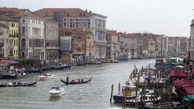 Gondoliers on the Grand Canal, Venice. UAE citizens will travel freely to Italy without a visa, from this spring. Betsy Vereckey / AP Photo