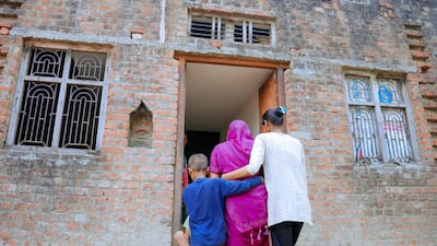 The family of Markandey Chauhan, who was killed in the Emirates Road crash, enter the home he was building for them in Uttar Pradesh, northern India. Photo: Burjeel Holdings