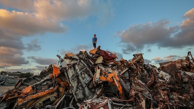 A Palestinian refugee boy stands on destroyed cars near his family house in Khan Younis refugee camp in Gaza on June 24, 2020. No algorithm manufactures a food ration or filters water. EPA