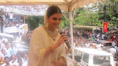 Aishwarya Rai Bachchan addresses fans from an outdoor stage at the opening of a jewellery store in Kochi, India. IANS