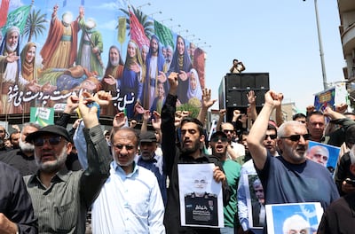A man holds up a poster of Islamic Revolutionary Guard Corps chief head Hossein Salami, who was killed in Israel's strikes. EPA