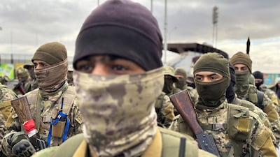 The Khaled Brigade, part of Hayat Tahrir Al Sham, holds a military parade in Damascus on December 27. Reuters