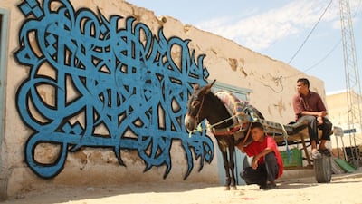 Photos of El Seed from his upcoming book, Lost Walls. This is in Douz, Tunisia. CREDIT: Courtesy El Seed
