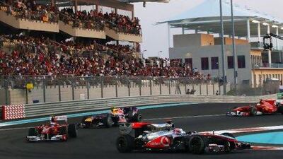 Jenson Button takes a turn at the Abu Dhabi Grand Prix last November. If an Emirati were on the track, you'd see more flags in the grandstand.