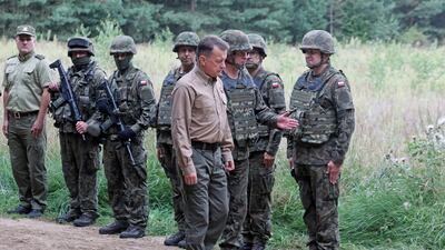 Polish Defence Minister Mariusz Blaszczak with troops at the Poland-Belarus border, where Warsaw plans to build a fence. EPA