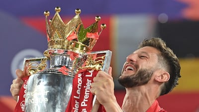 Liverpool's English midfielder Adam Lallana lifts the Premier League trophy. AFP
