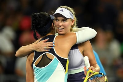 Caroline Wozniacki, right, embraces Kristie Ahn after winning their first round match at the Australian Open. EPA