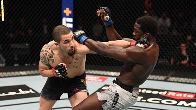 Robert Whittaker punches Jared Cannonier. Getty